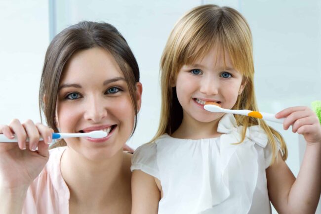 mother-daughter-brushing-teeth-bathroom (1)